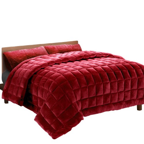 Red quilted doona on wooden bed