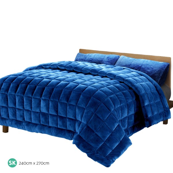 giselle bedding faux mink quilt blue super king Deep blue quilted bedspread on wooden bed