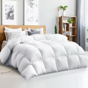 Fluffy white doona on modern bedroom bed