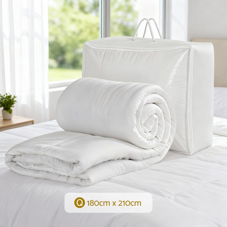 White quilt with storage bag on bed