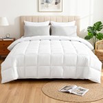 Neatly made bed with white quilt and cushions