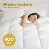 Woman sleeping under white all-season comforter