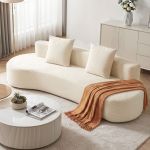 Modern cream sofa with rust throw blanket