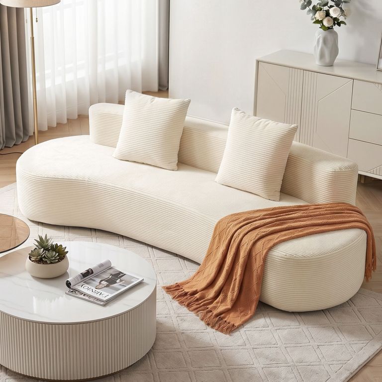 Modern cream sofa with rust throw blanket