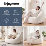 artiss single small boneless couch comfy bean bag for living room faux fur white Woman relaxing on plush bean bag chair indoors