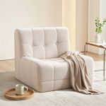 Cream boucle lounge chair with throw blanket