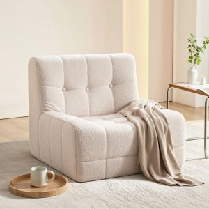 Cream boucle lounge chair with throw blanket