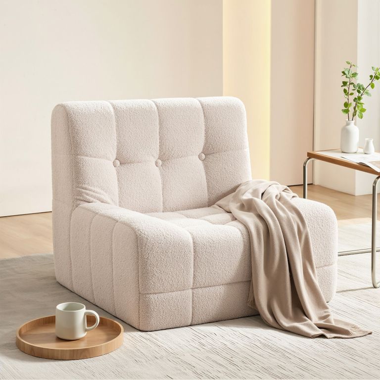 Cream boucle lounge chair with throw blanket