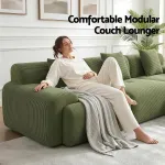 Woman relaxing on green modular couch lounger