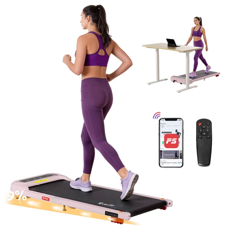 Woman walking on treadmill under standing desk