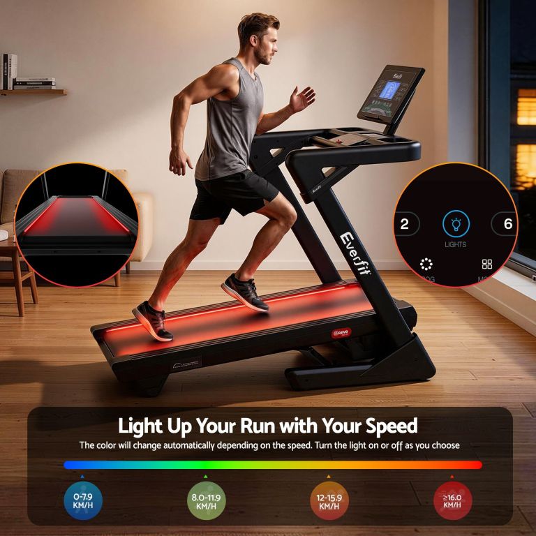 Man running on LED-lit smart treadmill indoors