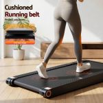 Woman walking on cushioned home treadmill