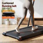 Woman walking on cushioned treadmill at home