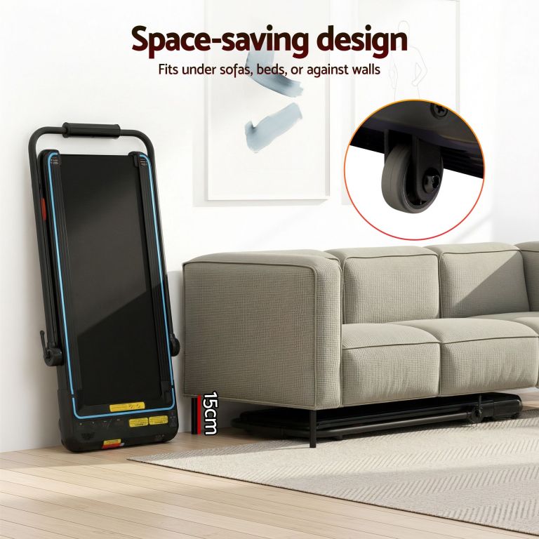 Foldable treadmill stored upright beside sofa