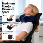 Woman using compact travel neck pillow at desk