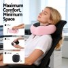 Woman using pink travel neck pillow in office
