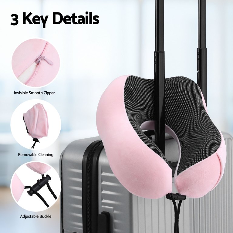 Pink travel neck pillow on suitcase handle