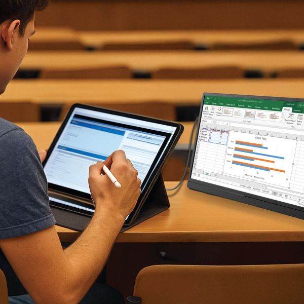 Student using tablet and laptop in lecture hall
