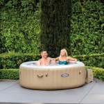 Couple relaxing in inflatable backyard spa