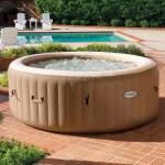 Inflatable spa on brick patio near pool