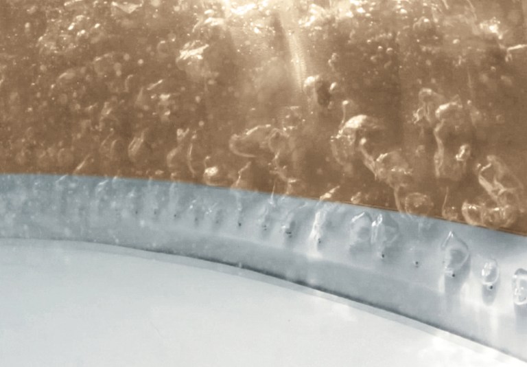 Close-up of fermenting liquid with bubbles in jar