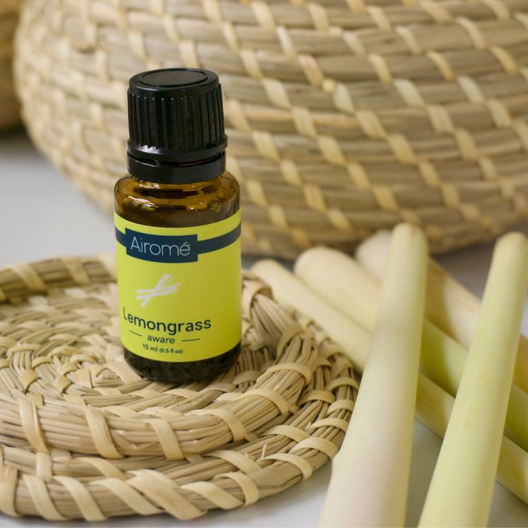 Lemongrass essential oil bottle with fresh stalks
