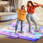Woman and girl dancing on interactive play mat