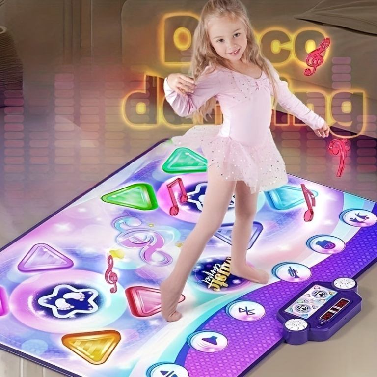 Young girl dancing on colourful light-up dance mat