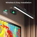 Wireless picture light above colourful wall art