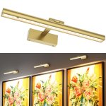 Brass LED picture light above framed floral artwork