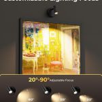 Adjustable wall spotlight illuminating framed artwork