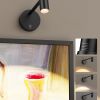 v1171 cb bom001448 00.jpg Adjustable black wall light above framed artwork