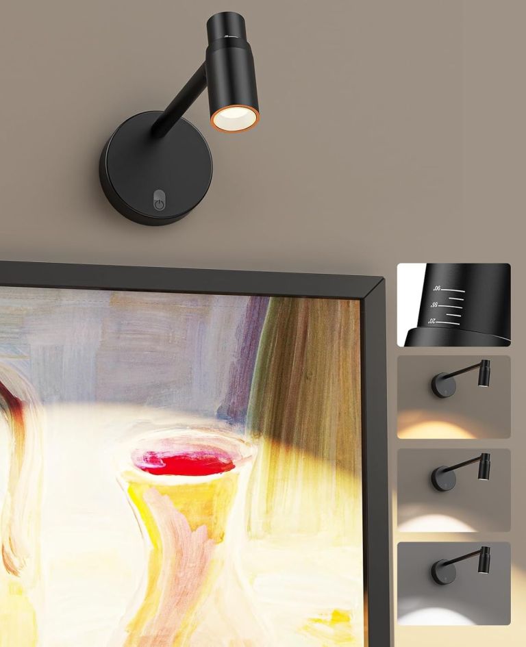 Adjustable black wall light above framed artwork