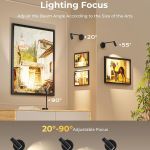 Adjustable wall spotlight illuminating framed artwork