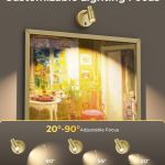 Adjustable gold picture light illuminating framed artwork