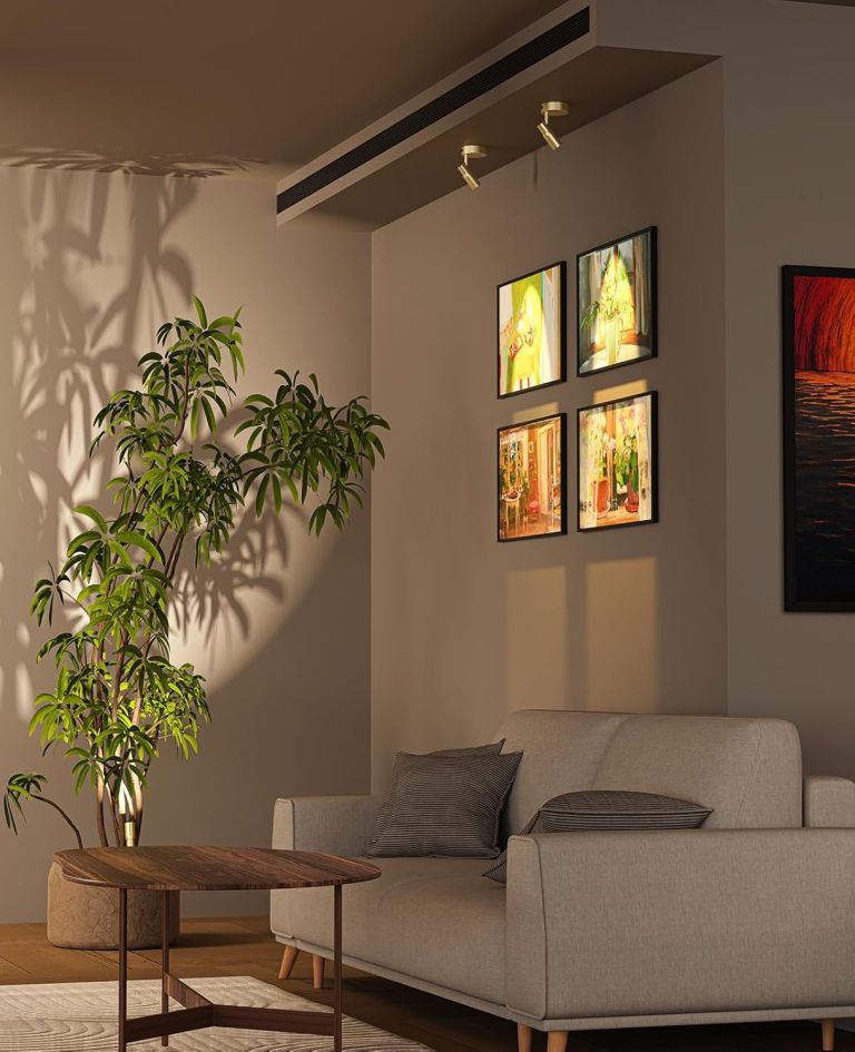 Modern living room with sofa, plant and artwork