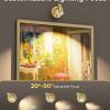 Adjustable wall spotlight illuminating framed artwork