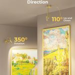Adjustable gold spotlight illuminating framed wall art