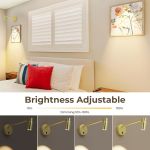 Adjustable brass wall lights above modern bedroom bed