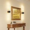 Framed landscape painting with modern wall sconces