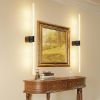 Framed landscape painting with modern wall sconces