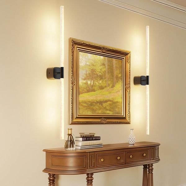 Framed landscape painting with modern wall sconces