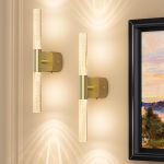 Modern brass wall sconces with glowing glass tubes
