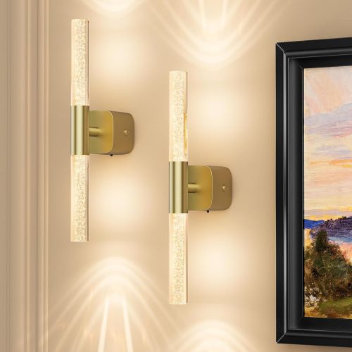 Modern brass wall sconces with glowing glass tubes