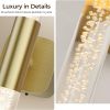 Brushed gold wall light with bubble crystal