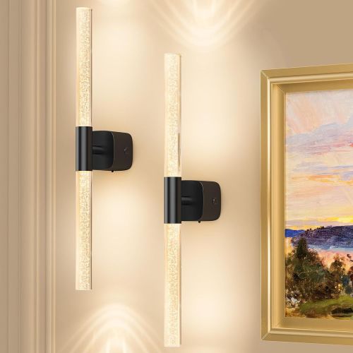 Modern wall sconces beside framed landscape painting