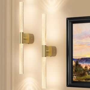Modern brass wall sconces beside framed artwork