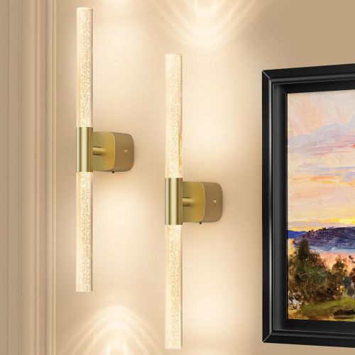 Modern brass wall sconces beside framed artwork