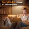 Man using laptop under eye-friendly wall light