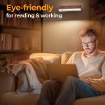 Man using laptop under eye-friendly wall light